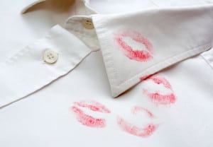 close up of white shirt and red lipstick on it