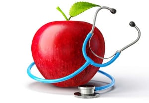 concept red apple with stethoscope on white
