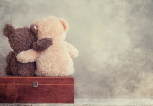 two teddy bears holding in one's arms