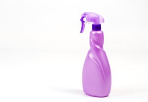 A bright purple spray bottle on white background.