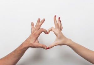 Couple hands making heart gesture