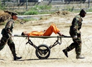 File photograph shows military police bringing a detainee to an interrogation room for questioning at the Naval Base at Guantanamo Bay -SIN127_SECURITY_GUANTANAMO_.JPG-