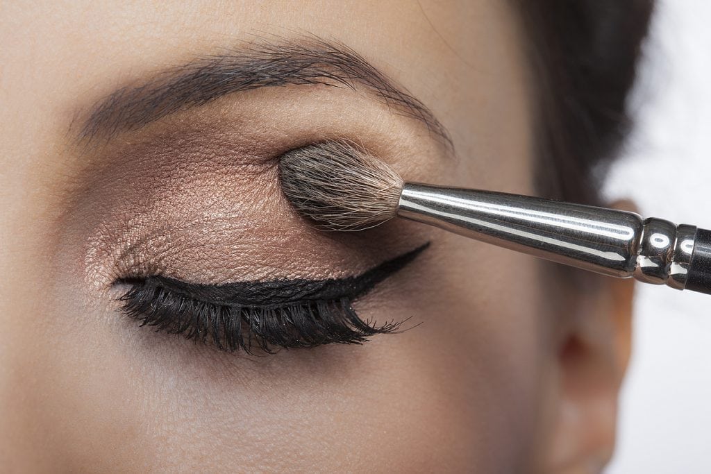 Makeup close-up. Eyebrow makeup, long eyelashes, brush