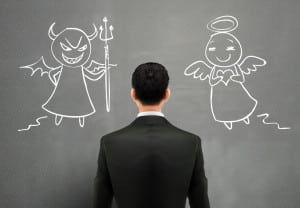 businessman facing of devil and angel over grey wall