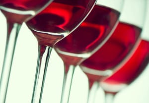 Row of the wine glasses on green light. Selective focus