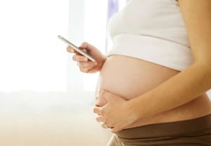 Pregnant woman with mobile phone